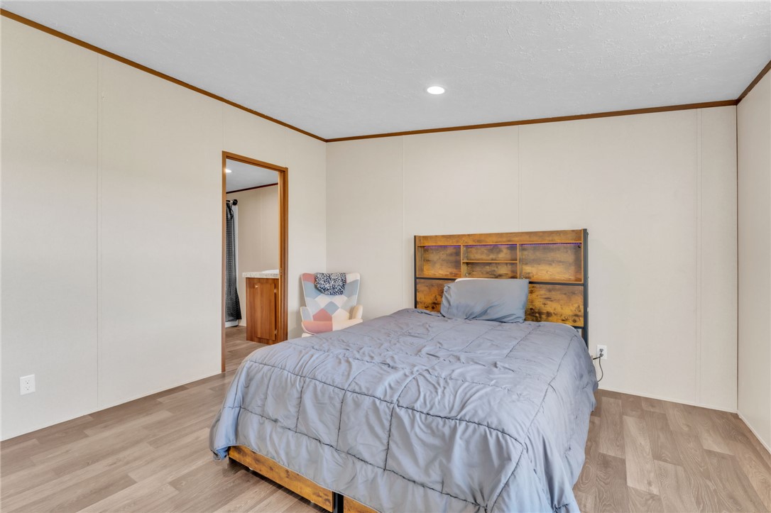 5303 Highway 413 Iva, SC 29655 - Photo 16 of 27 This cozy bedroom features durable flooring and an adjoining private bathroom for comfort and convenience.