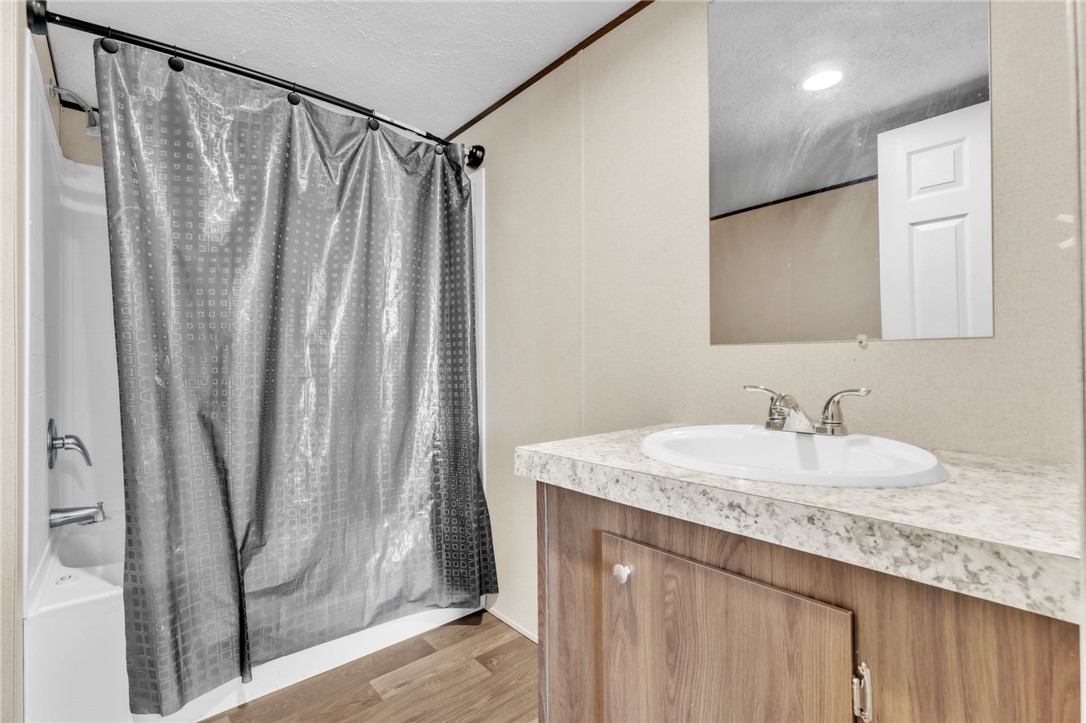 5303 Highway 413 Iva, SC 29655 - Photo 17 of 27 This clean and inviting bathroom features a convenient shower and a vanity with ample counter space.