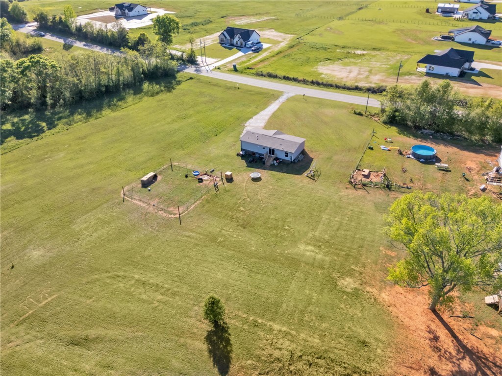 5303 Highway 413 Iva, SC 29655 - Photo 22 of 27 Expansive green acreage surrounds this home, offering abundant space and rural tranquility.