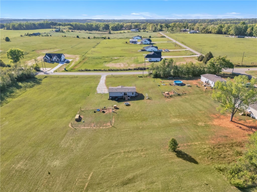 5303 Highway 413 Iva, SC 29655 - Photo 23 of 27 Expansive green landscape with residential properties offers serene, open-air living.