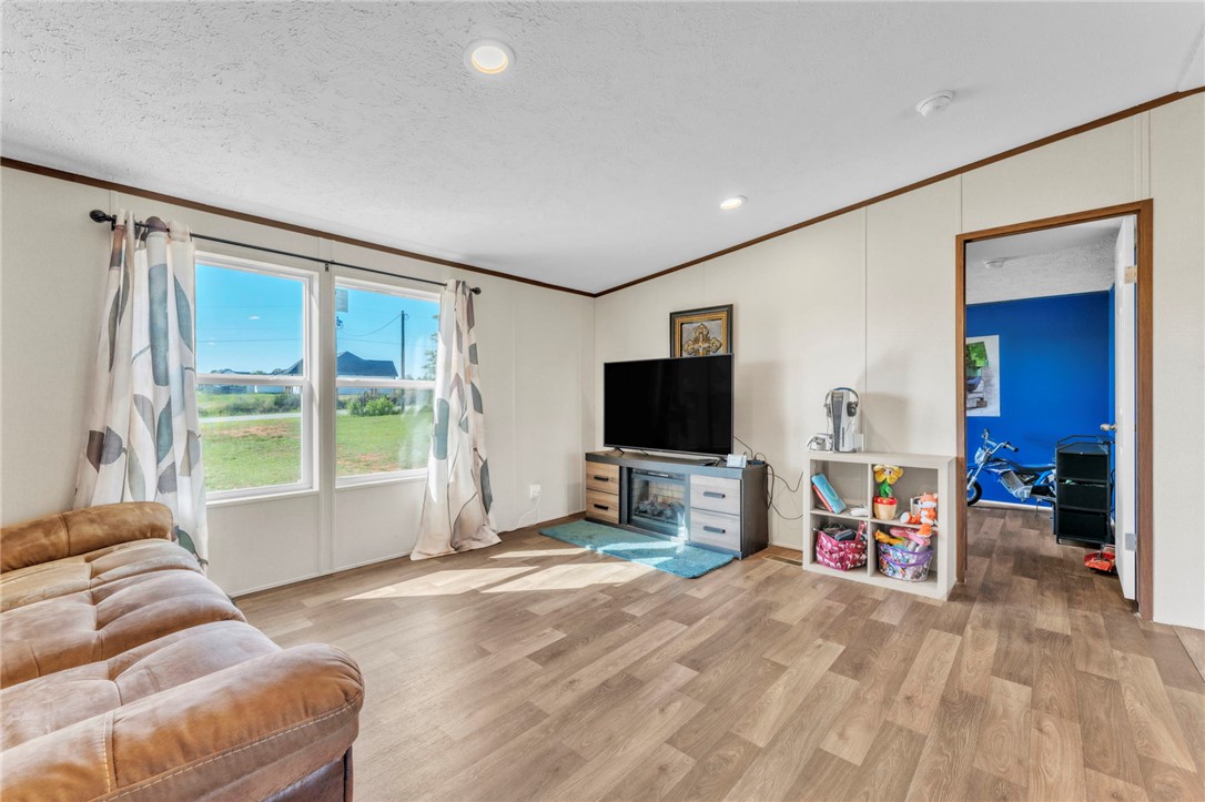 5303 Highway 413 Iva, SC 29655 - Photo 5 of 27 This bright living room offers an inviting atmosphere with ample natural light.