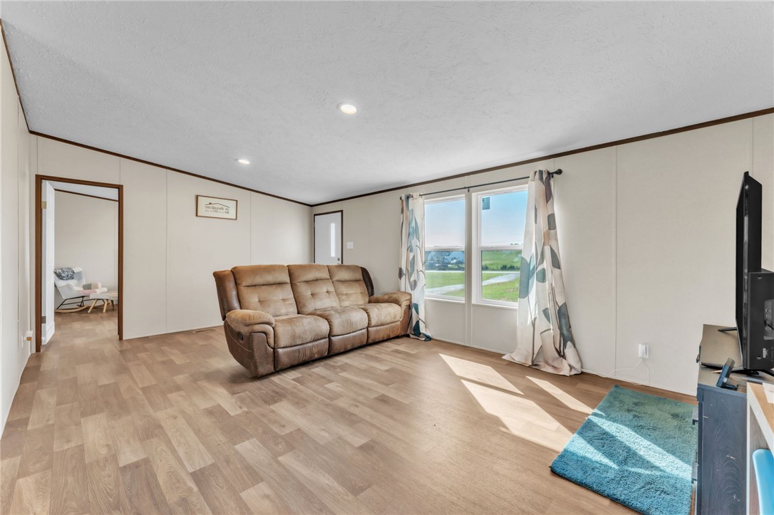 5303 Highway 413 Iva, SC 29655 - Photo 6 of 27 Bright and open, this living space features durable flooring and abundant natural light.