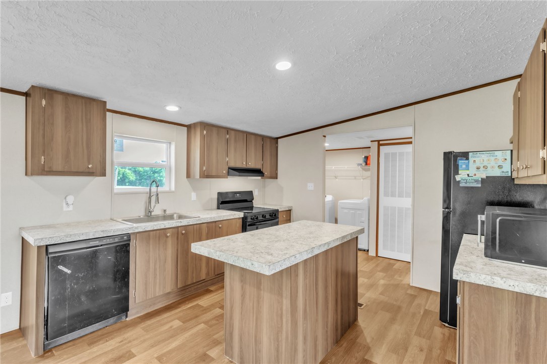 5303 Highway 413 Iva, SC 29655 - Photo 8 of 27 This bright kitchen features wood cabinetry and ample counter space for daily living.