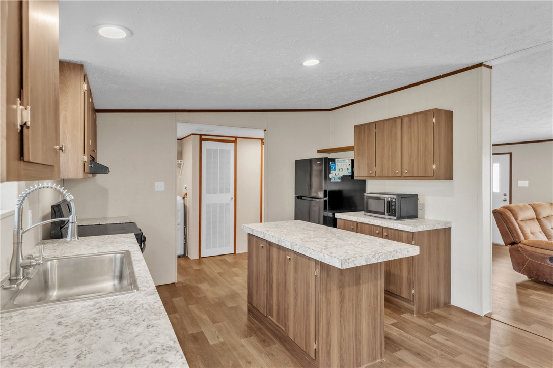 5303 Highway 413 Iva, SC 29655 - Photo 9 of 27 This bright kitchen features ample counter space, modern appliances, and a convenient island for everyday living.