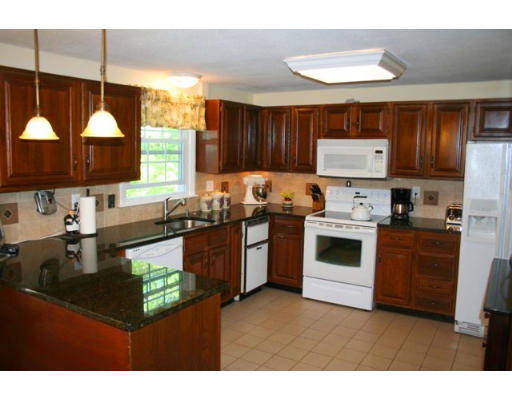 5 Brady Rd Extension Westborough, MA 01581 - Photo 6 of 16 a kitchen with kitchen island granite countertop a sink cabinets and stainless steel appliances
