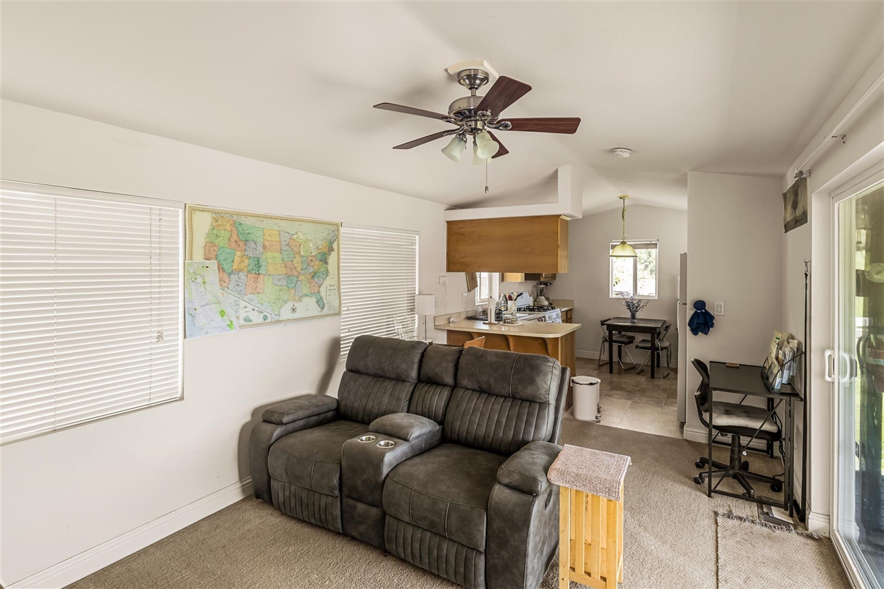 16554 Cocoran Gray Road Groveland, CA 95321 - Photo 25 of 38 Tiled living room featuring vaulted ceiling and ceiling fan