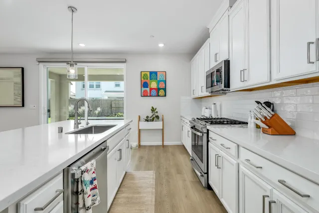 a kitchen with kitchen island a sink stove and cabinets