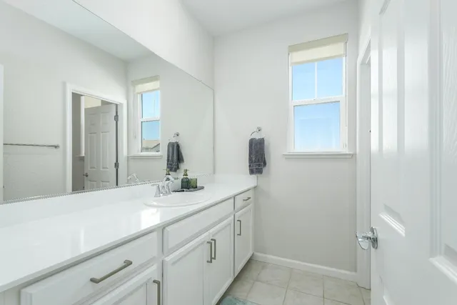 a bathroom with a double vanity sink and mirror