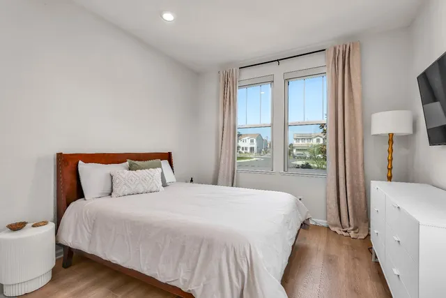 a bedroom with a large bed and a large window