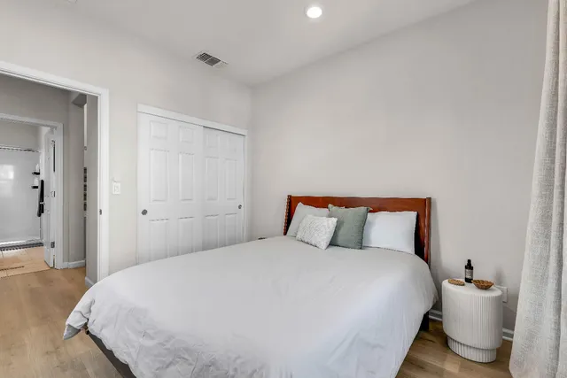 a bedroom with a bed and a lamp