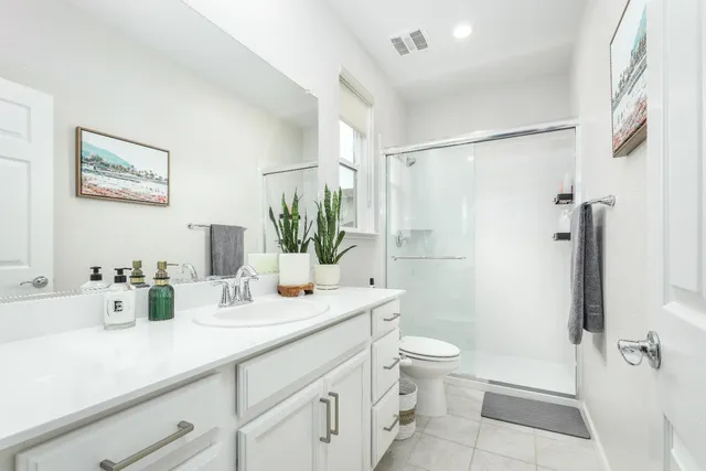 a view of a hallway with white cabinets