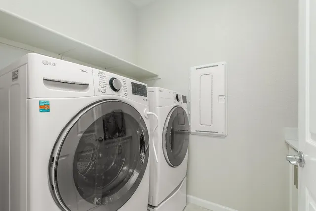 a view of kitchen with sink refrigerator and dining table