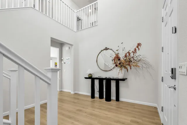 a view of a hallway with wooden floor and entryway