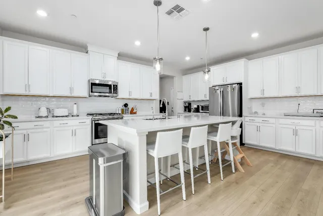 a kitchen with appliances a sink and cabinets