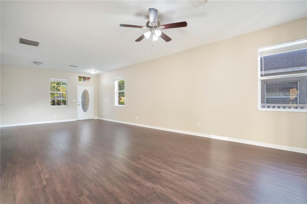 15031 Skip Jack Loop Lakewood Ranch, FL 34202 - Photo 7 of 27 a view of an empty room with window and wooden floor