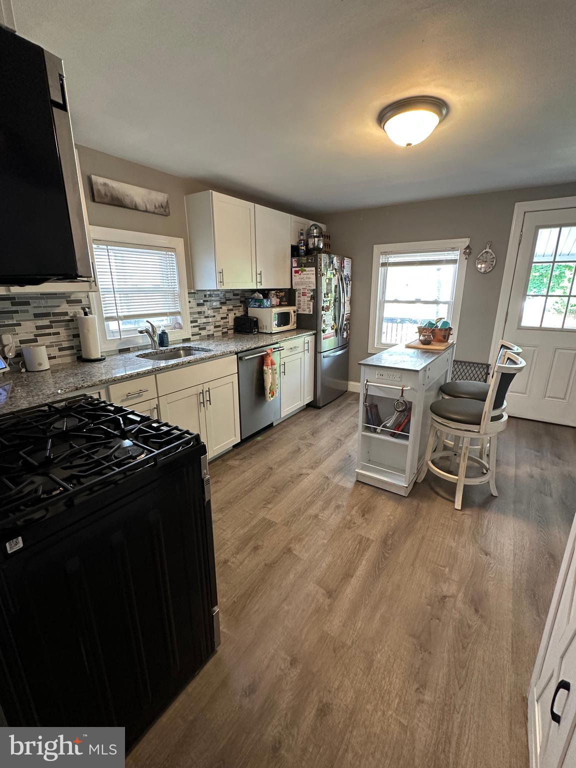 203 Mill Street Mount Holly, NJ 08060 - Photo 8 of 19 a kitchen with a stove a sink and a refrigerator