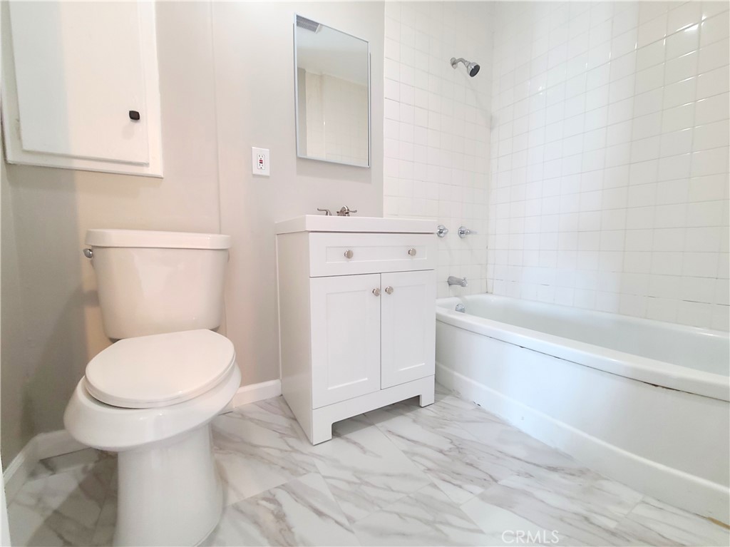 908 West Hays Street, Unit A Banning, CA 92220 - Photo 12 of 12 a bathroom with a sink a toilet and bathtub