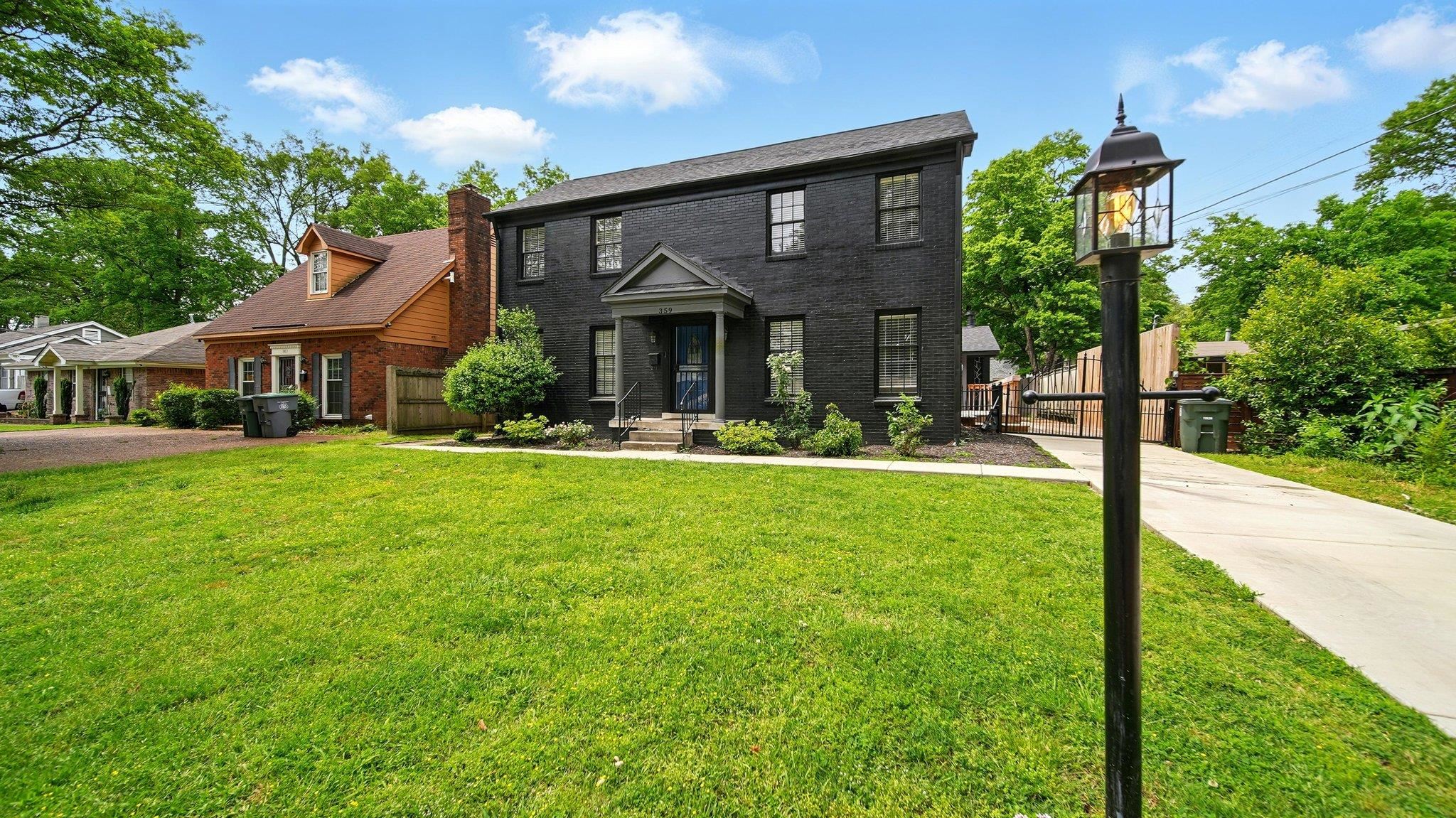 359 South Fenwick Road Memphis, TN 38111 - Photo 2 of 31 Colonial house featuring brick siding, a chimney, and a gate