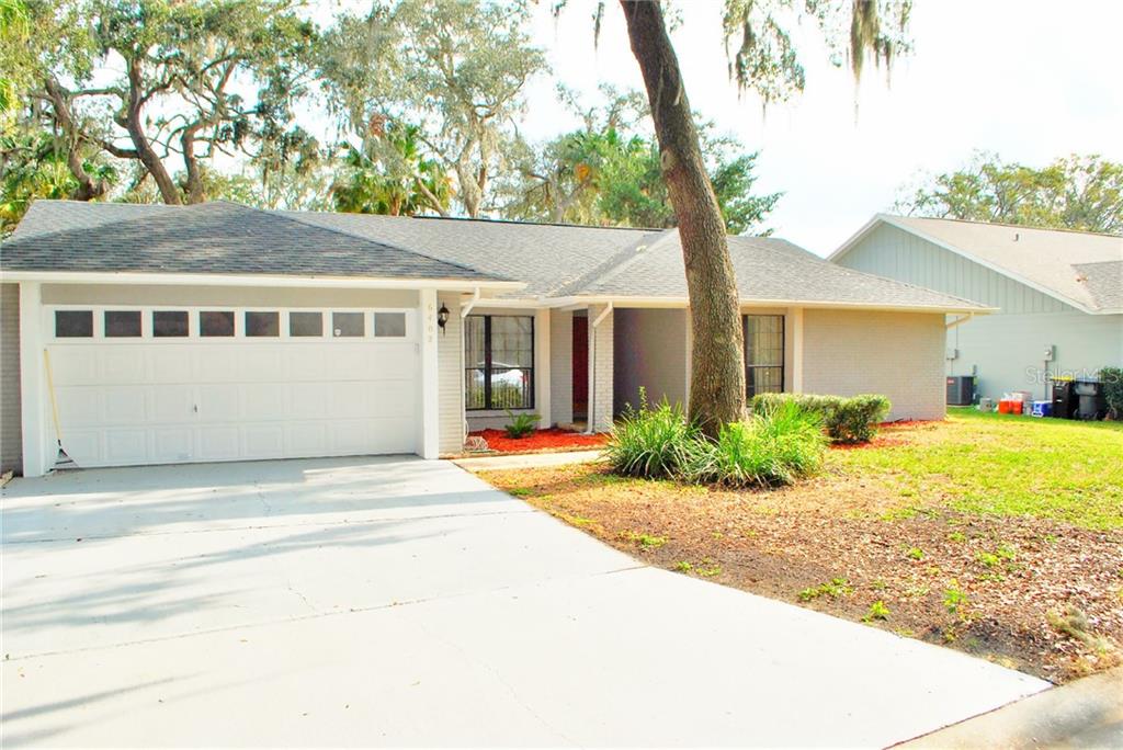 a front view of a house with a garden and patio
