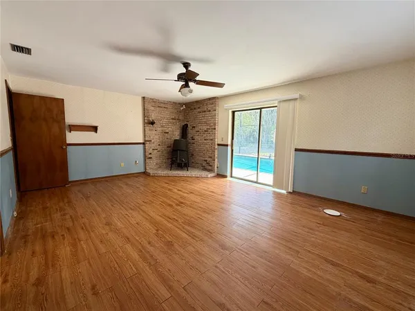 wooden floor in an empty room with a window