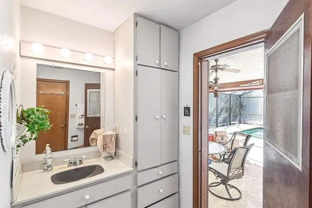 a bathroom with a sink a mirror and a shower
