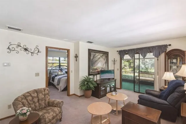 a view of a house with backyard and sitting area