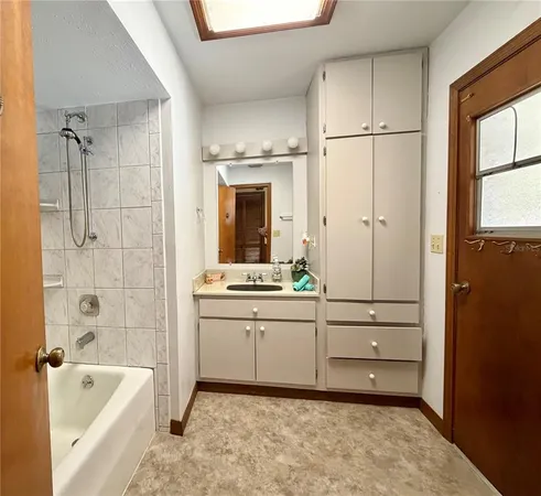 a utility room with cabinets washer and dryer