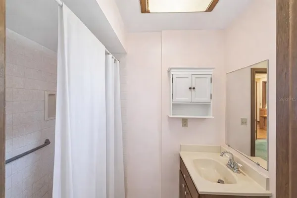 a bathroom with a double vanity sink and a mirror
