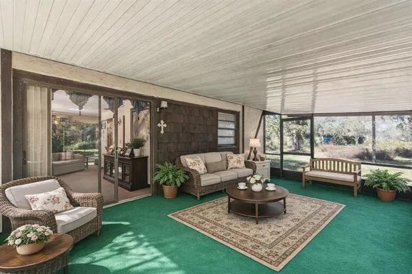 a view of a porch with wooden floor and iron stairs