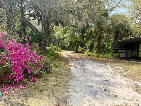 an aerial view of a house with yard