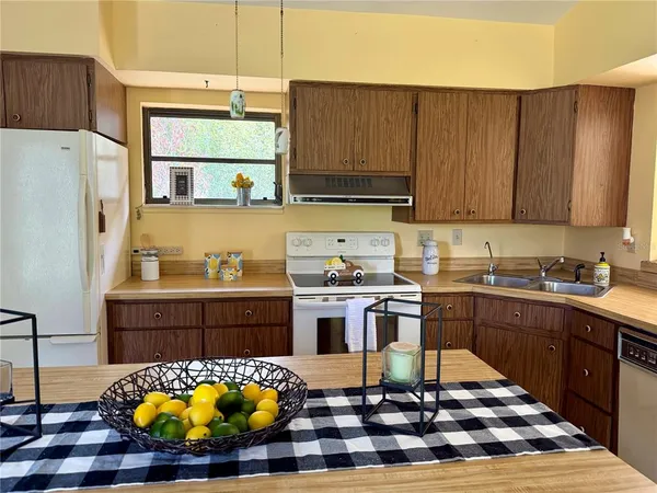 a kitchen with stainless steel appliances a sink stove and cabinets