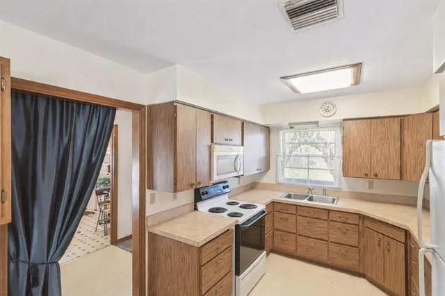 a kitchen with stainless steel appliances a sink and cabinets