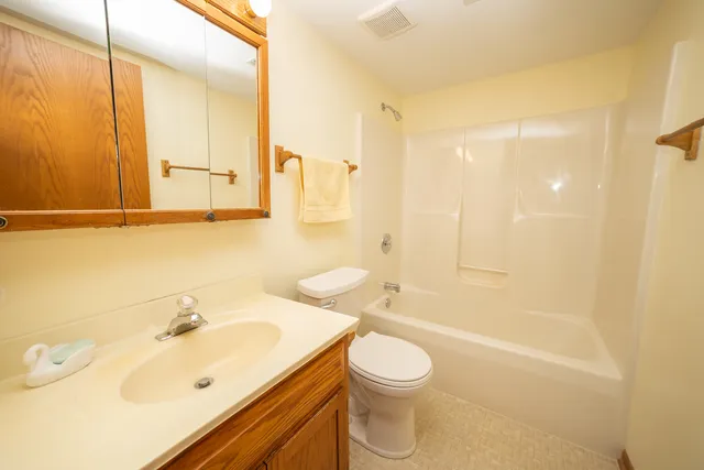 an empty room with a window and a ceiling fan