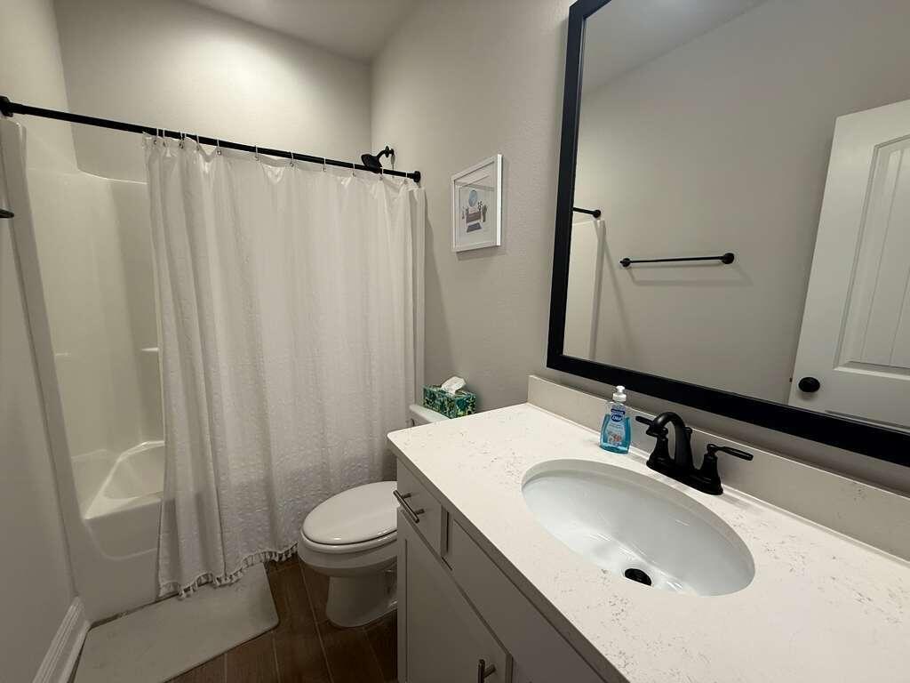 115 Apollo Avenue Freeport, FL 32439 - Photo 18 of 26 a bathroom with a sink toilet and shower