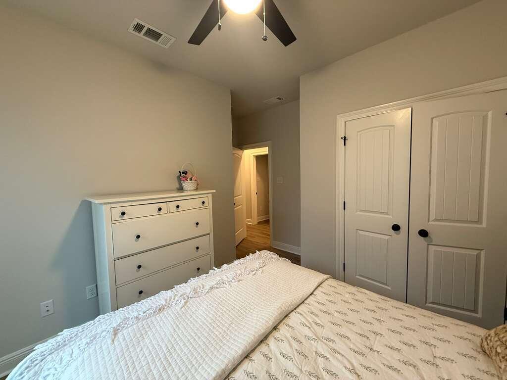 115 Apollo Avenue Freeport, FL 32439 - Photo 20 of 26 a bedroom with a bed and a chandelier
