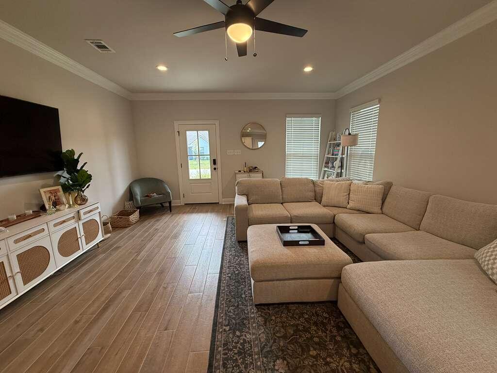 115 Apollo Avenue Freeport, FL 32439 - Photo 2 of 26 a living room with furniture and a flat screen tv