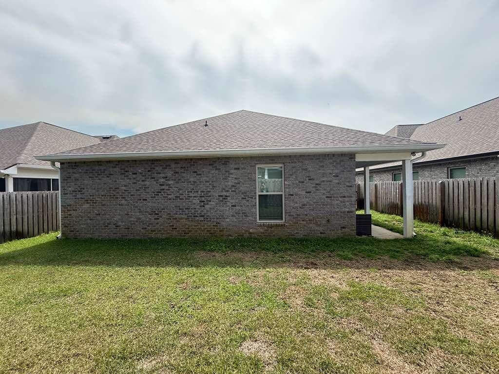 115 Apollo Avenue Freeport, FL 32439 - Photo 23 of 26 a backyard of a house with lots of green space