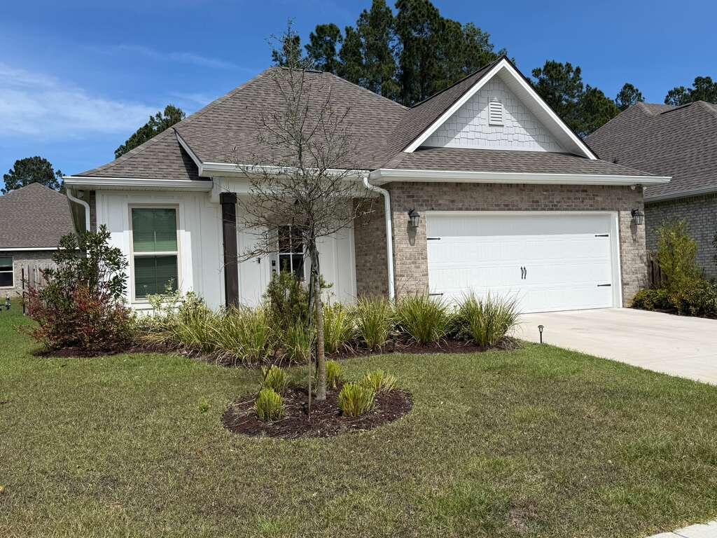 115 Apollo Avenue Freeport, FL 32439 - Photo 24 of 26 a front view of a house with a yard