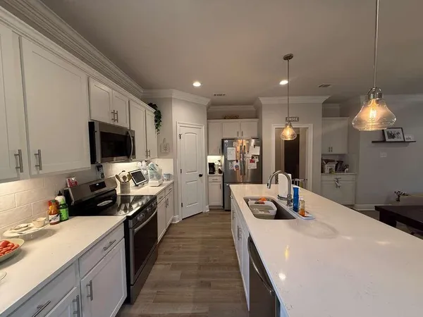 a kitchen with counter top space appliances and cabinets