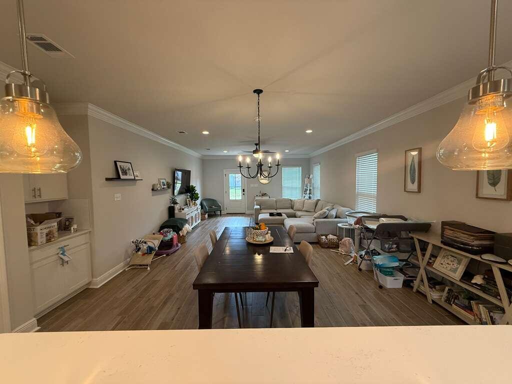 115 Apollo Avenue Freeport, FL 32439 - Photo 10 of 26 a living room with lots of furniture and a chandelier