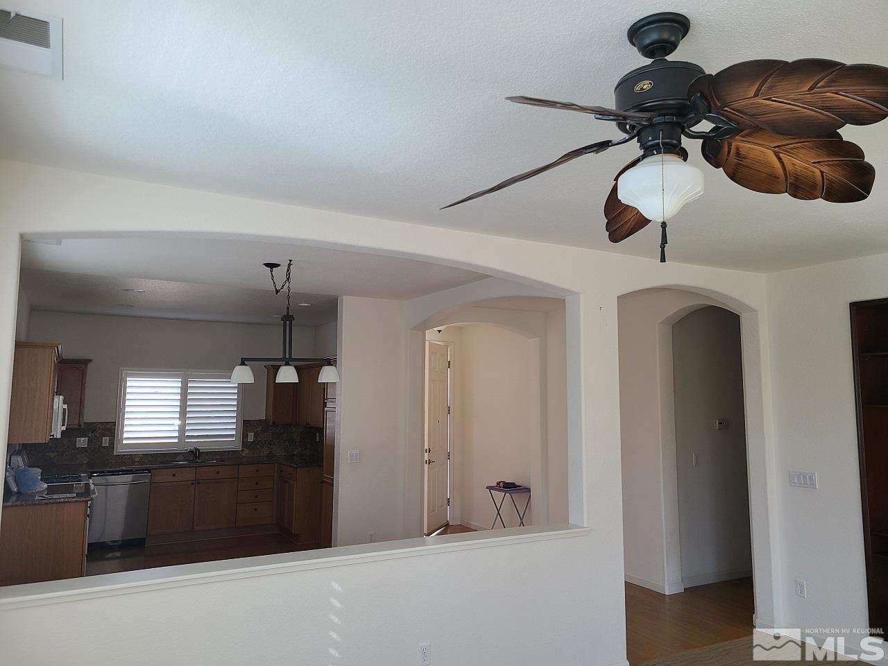 10350 Rosemount Drive Reno, NV 89521 - Photo 6 of 13 a kitchen with a refrigerator and chandelier