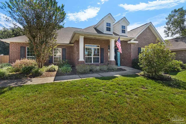 a front view of a house with a yard and porch