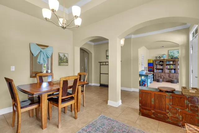 a dining room with furniture and a chandelier
