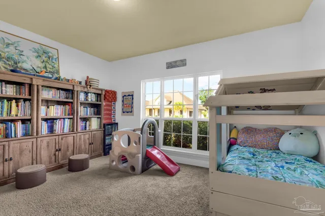 a bedroom with furniture and a book shelf