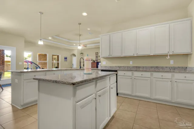a kitchen with granite countertop a sink and cabinets