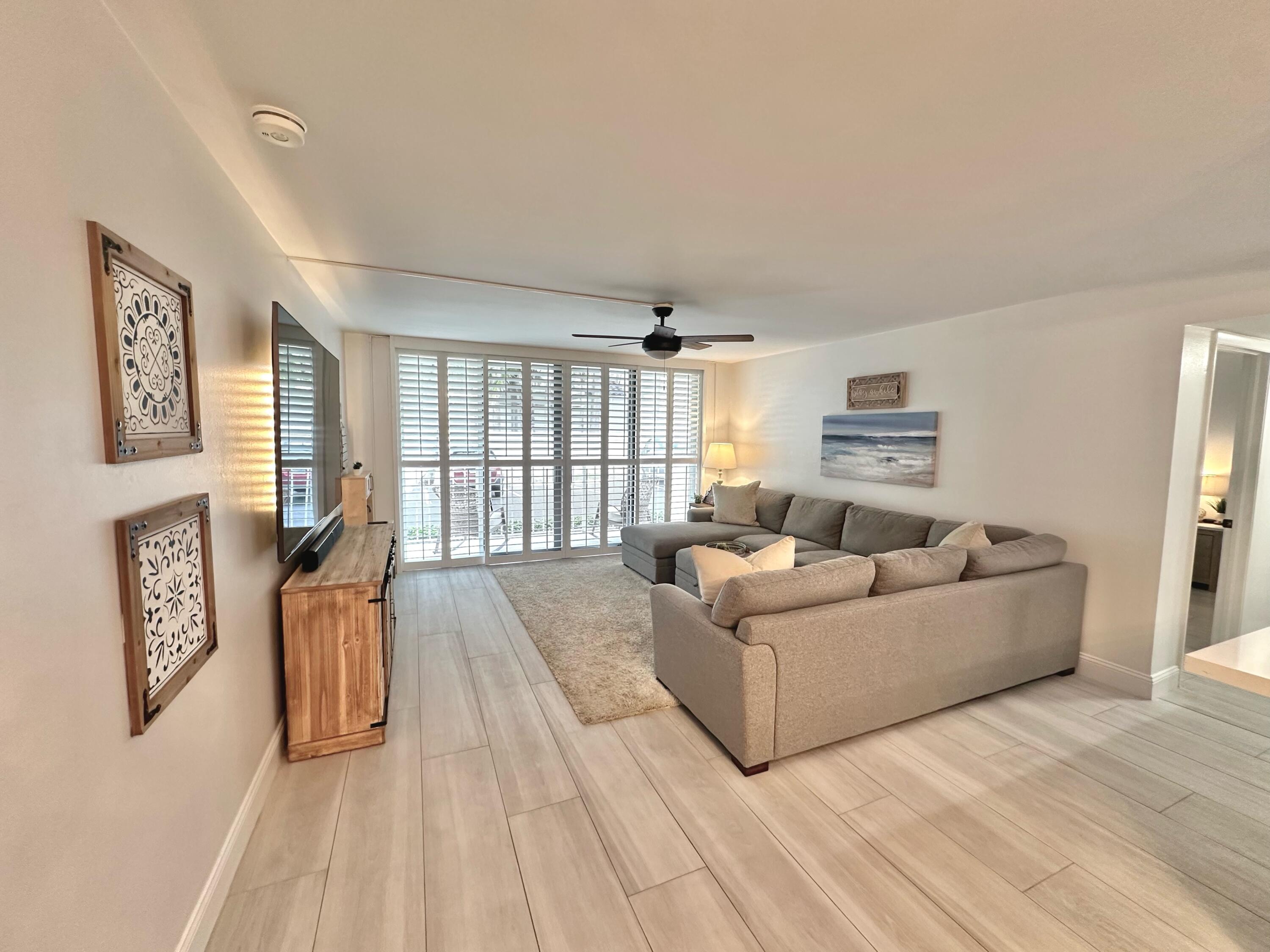 630 Ocean Drive, Unit 105 Juno Beach, FL 33408 - Photo 12 of 37 a living room with furniture and a window