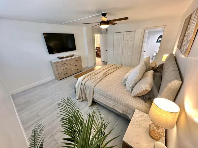 a bedroom with a bed and a flat screen tv