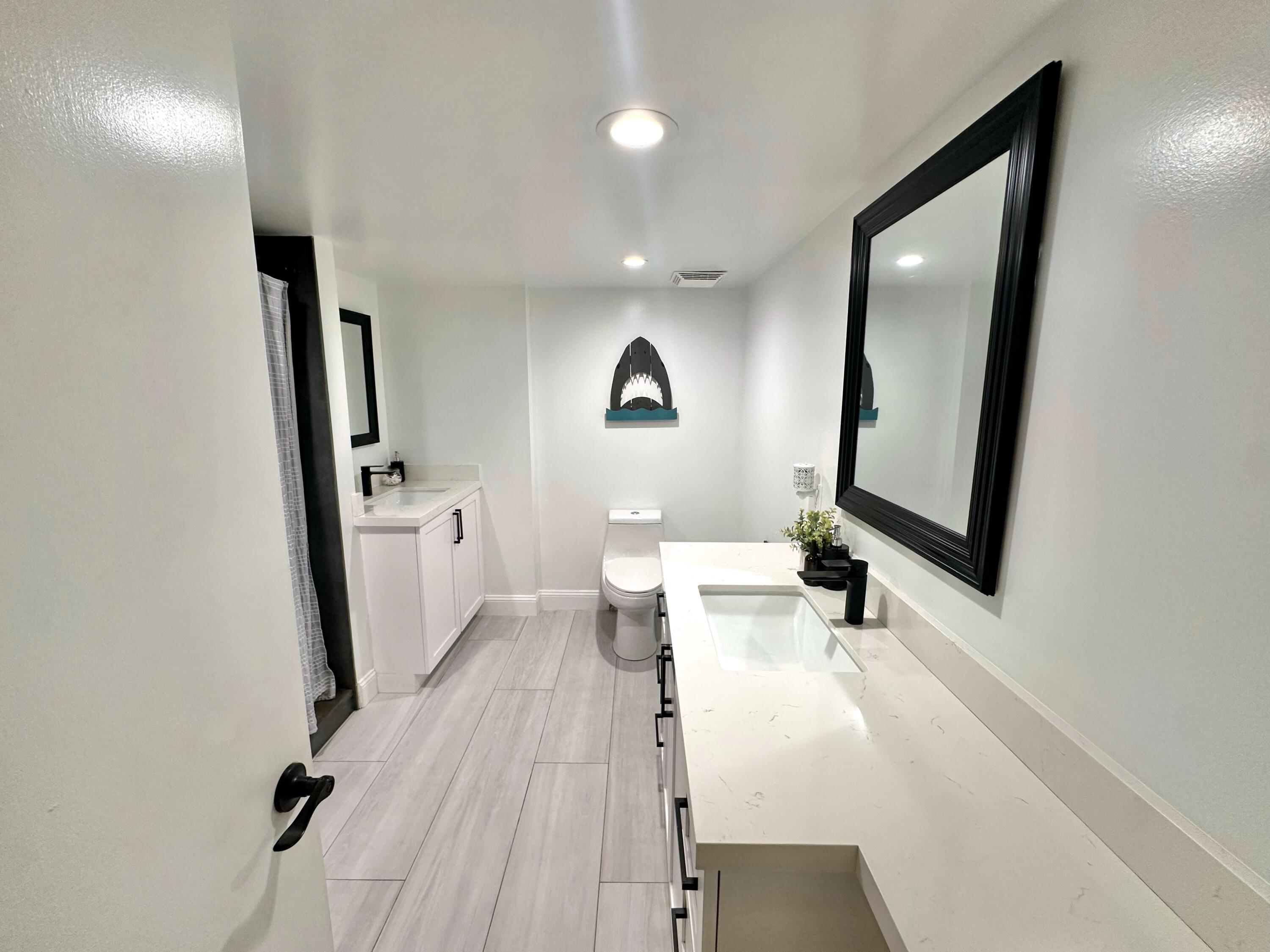 630 Ocean Drive, Unit 105 Juno Beach, FL 33408 - Photo 15 of 37 a view of a living room with a sink and wooden floor