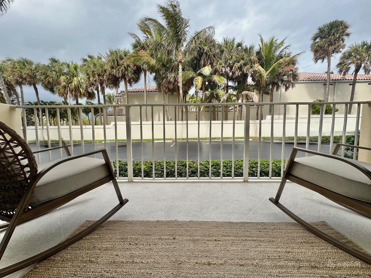 630 Ocean Drive, Unit 105 Juno Beach, FL 33408 - Photo 25 of 37 a view of outdoor space with swimming pool and furniture