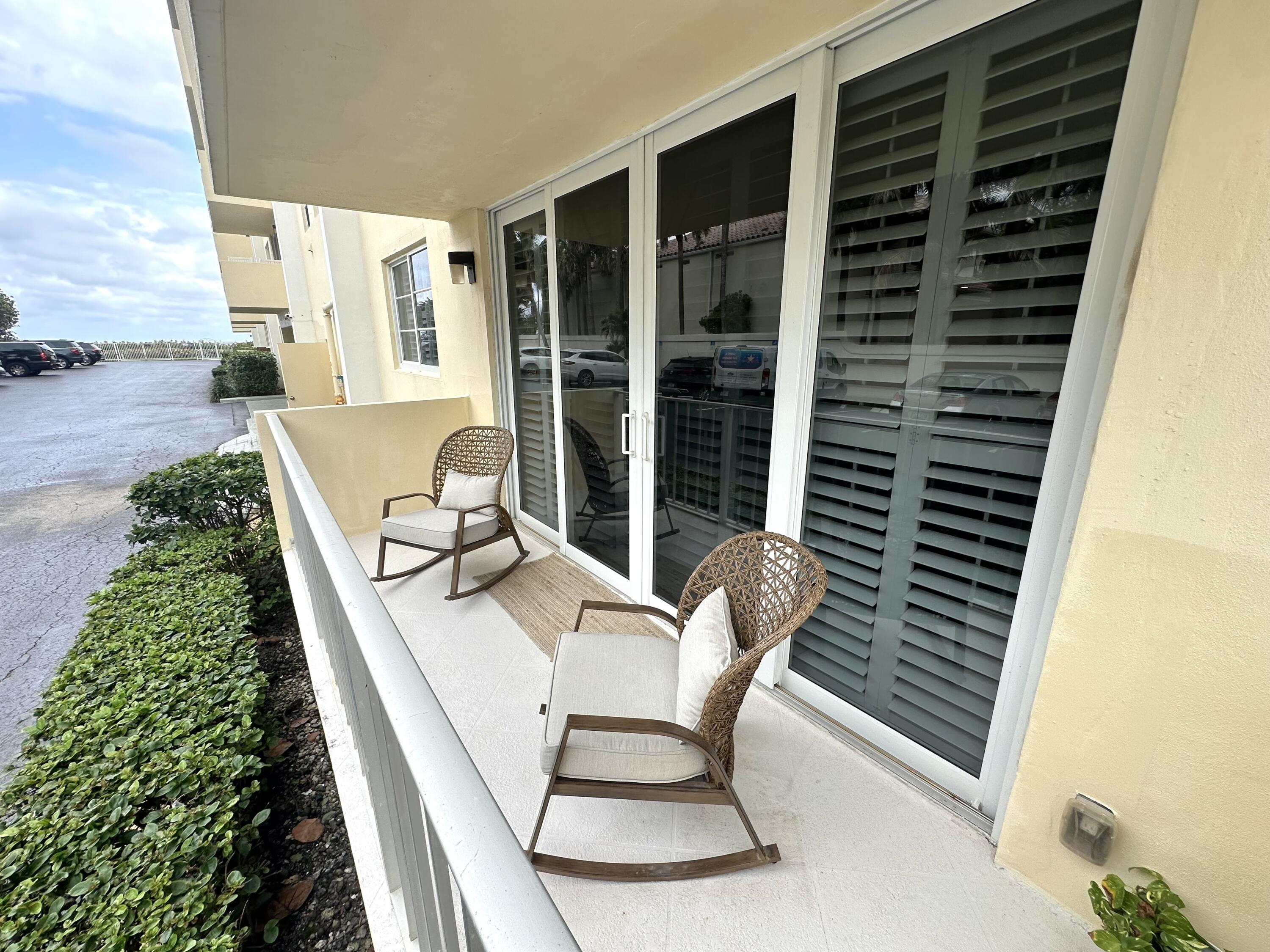630 Ocean Drive, Unit 105 Juno Beach, FL 33408 - Photo 26 of 37 a balcony with table and chairs